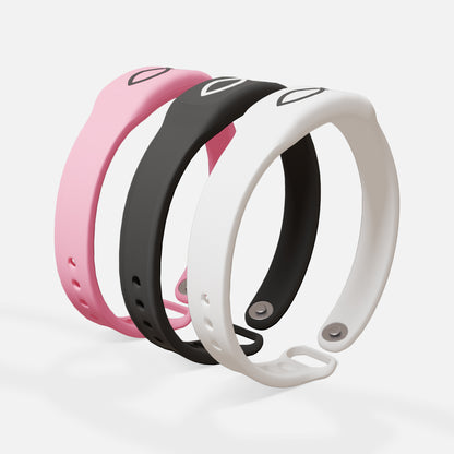 Three colorful fitness trackers on a light gray background